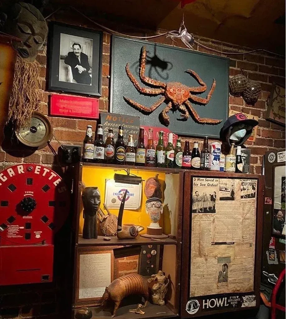 A wall of quirky decorations including a large crab and beer bottles.