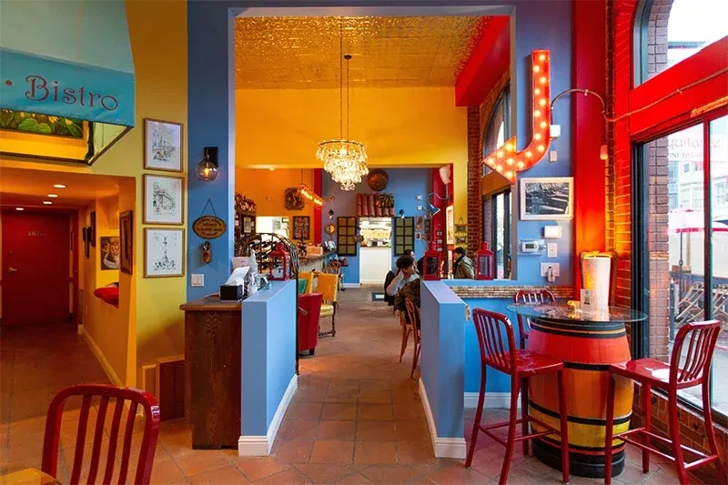A brightly colored bistro with red, blue, and yellow walls and decor.