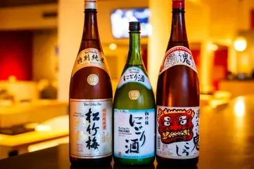 Three bottles of sake, with Japanese labels, on a bar.