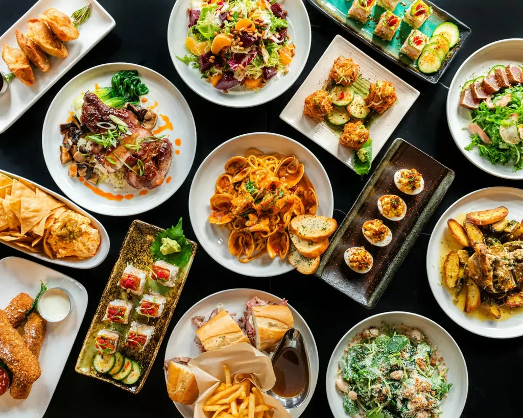 An overhead view of a table full of various delicious dishes.