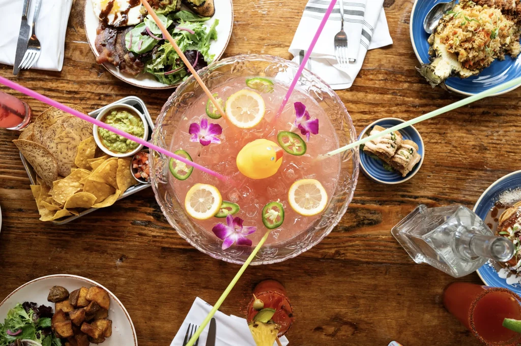 Overhead view of a vibrant table filled with food and drinks.