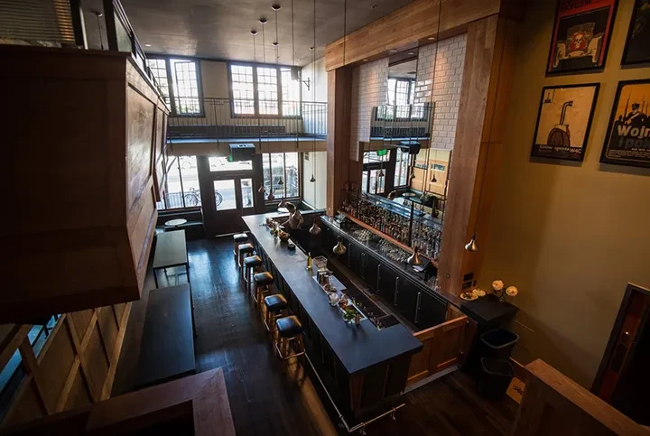 An aerial view of a two-story bar with a long counter.