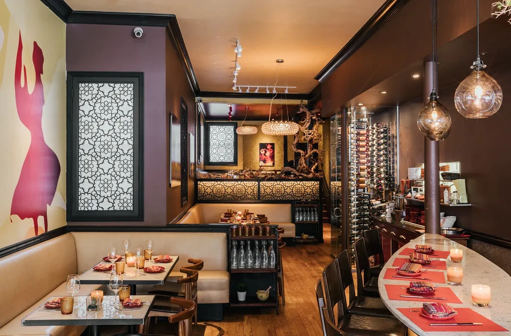 Upscale restaurant with modern decor, wine cellar, and bar seating.
