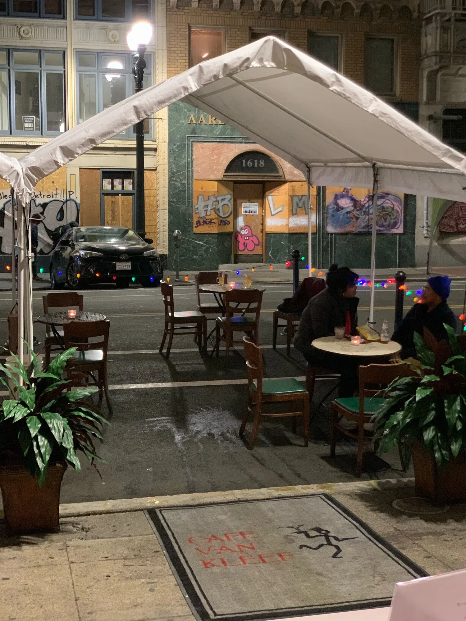 Outdoor dining at Cafe Van Kleef at night under a tent.