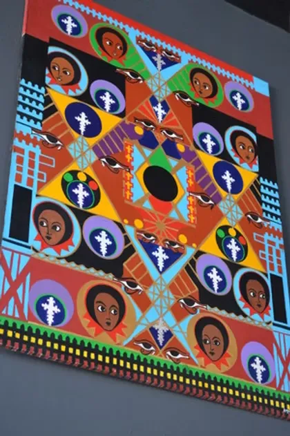 Colorful geometric painting featuring stylized faces, crosses, and birds.