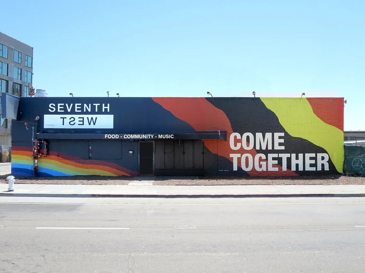 Seventh West building with colorful "Come Together" mural.