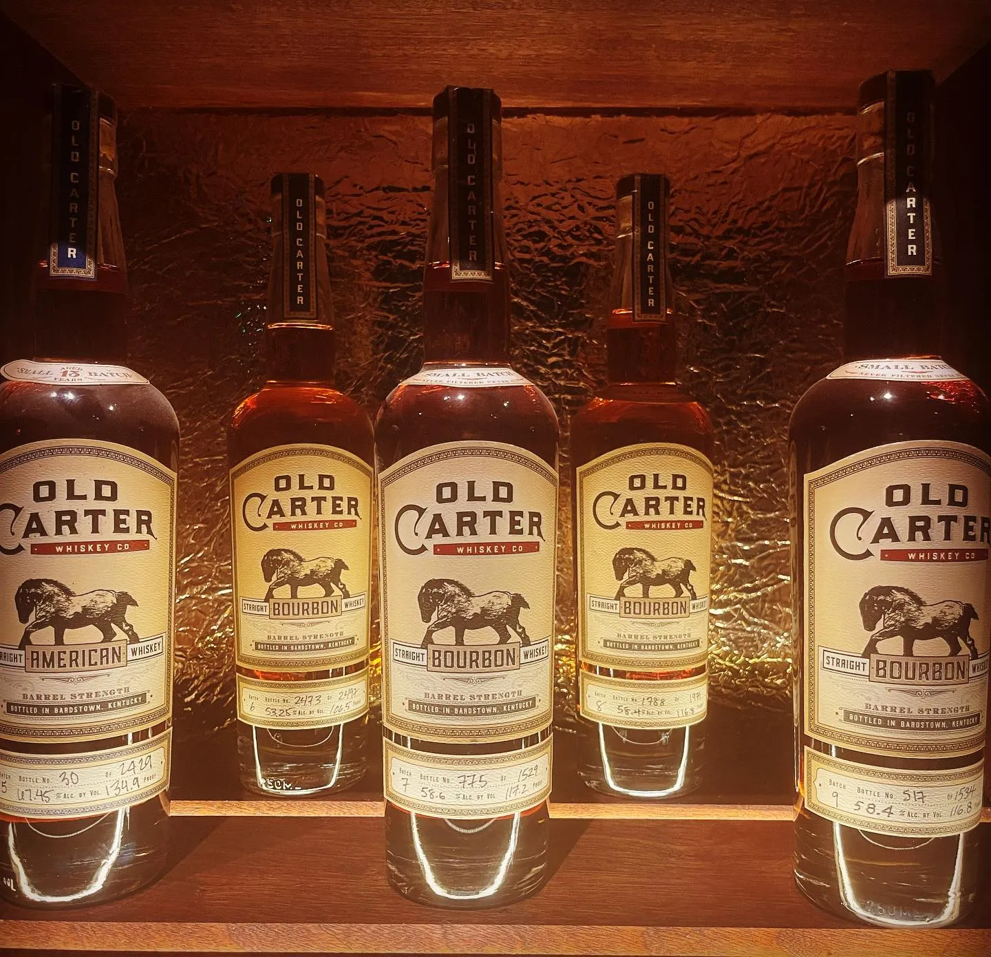 Five Old Carter straight American whiskey and bourbon bottles.