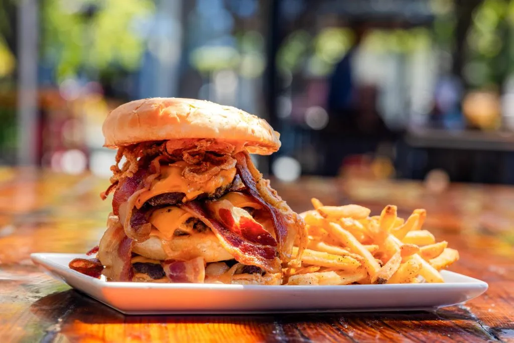 Big burger with bacon, cheese, crispy onions, and fries.