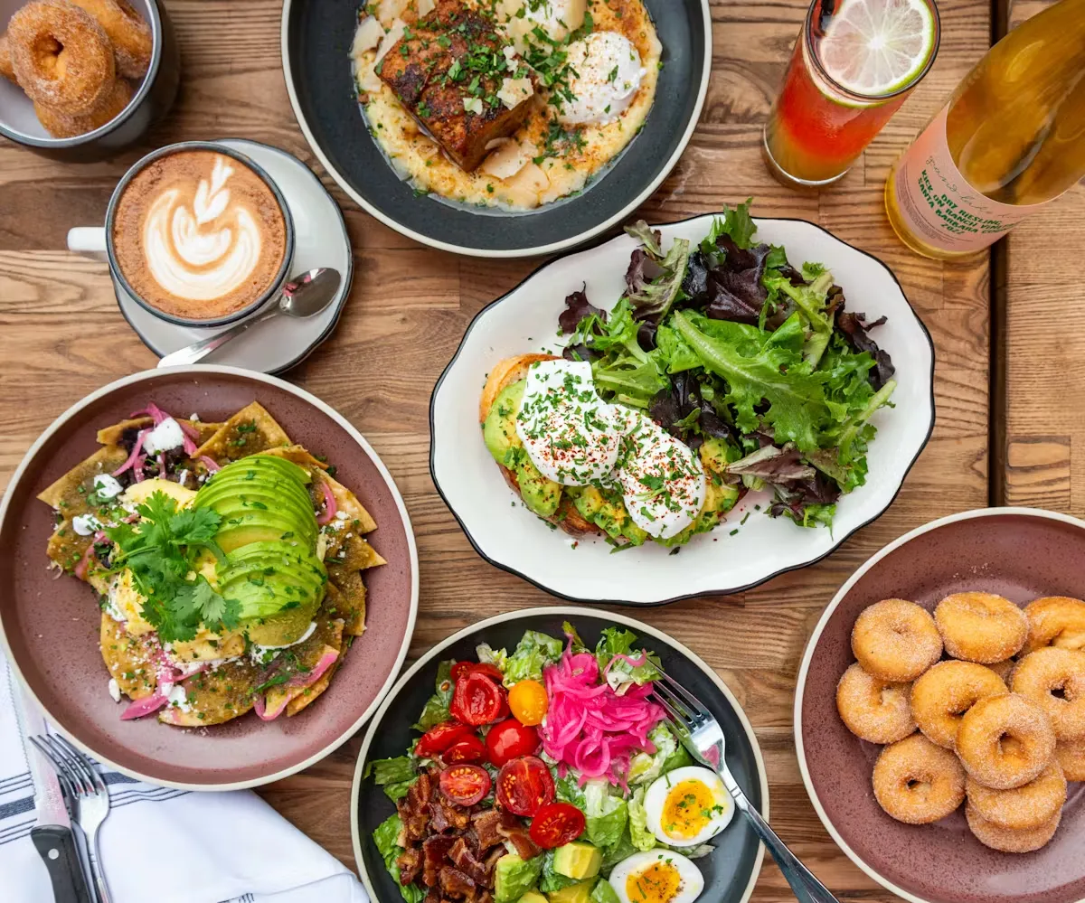 Overhead view of a table laden with various breakfast and brunch dishes.