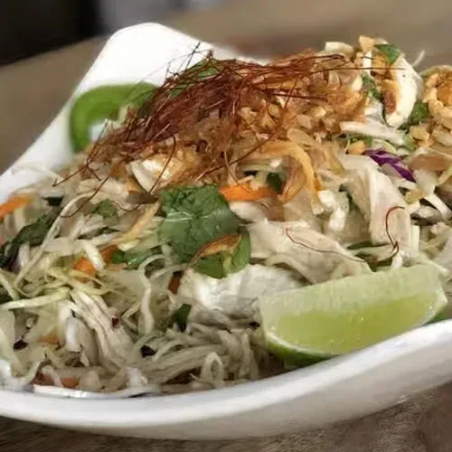 Shredded chicken and cabbage salad with mint, fried shallots, and lime.