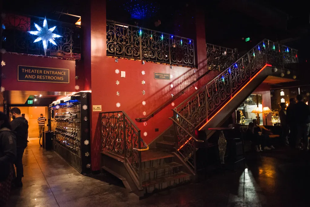 Interior with ornate staircase, red walls, star, and snowflake decorations.