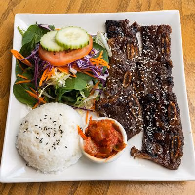 Korean BBQ short ribs, white rice, side salad, and kimchi.