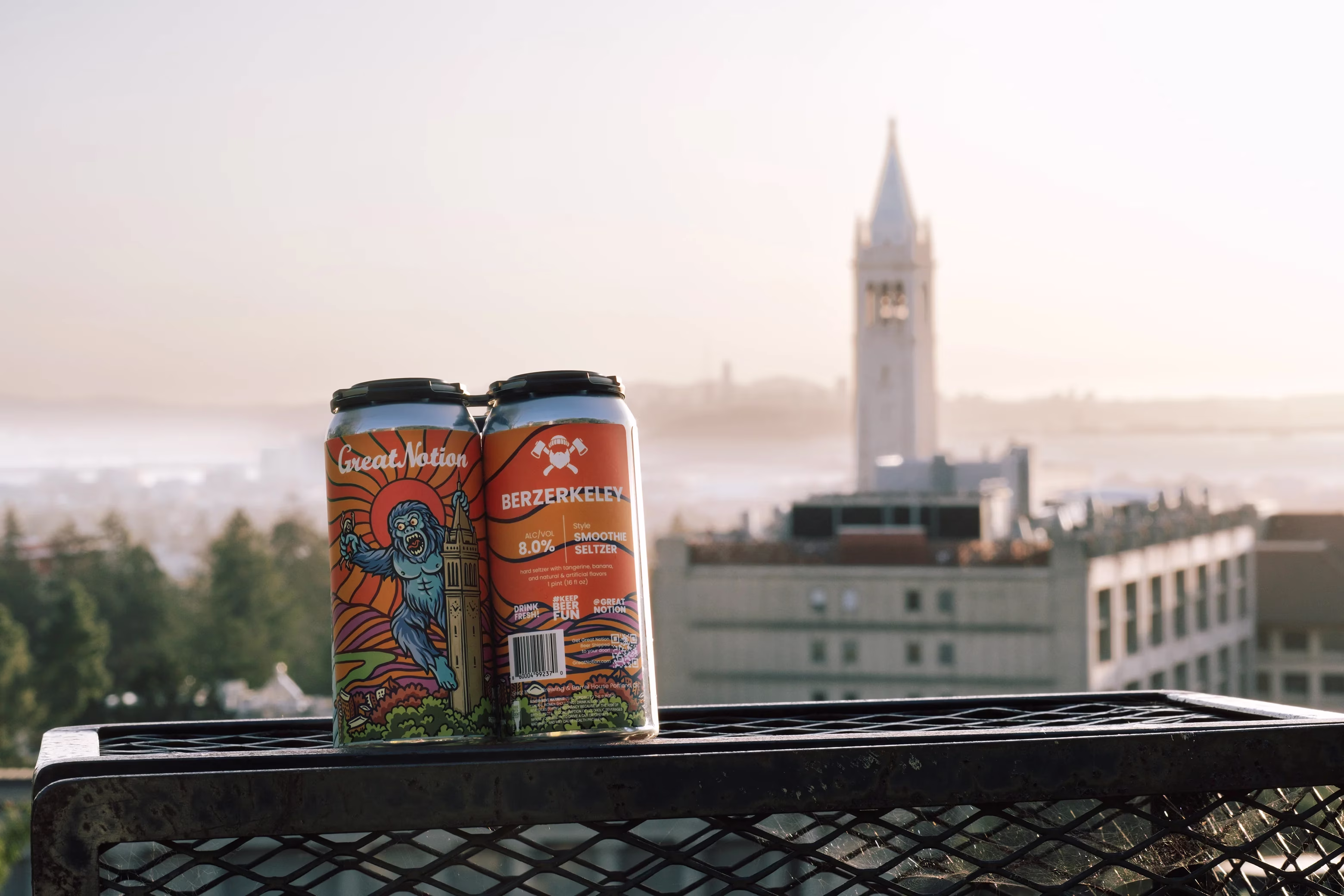 Great Notion Berzerkeley cans on a railing with Berkeley cityscape.