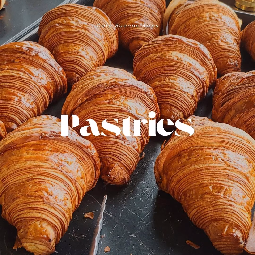 Golden brown croissants on a dark tray, with 'Pastries' text.