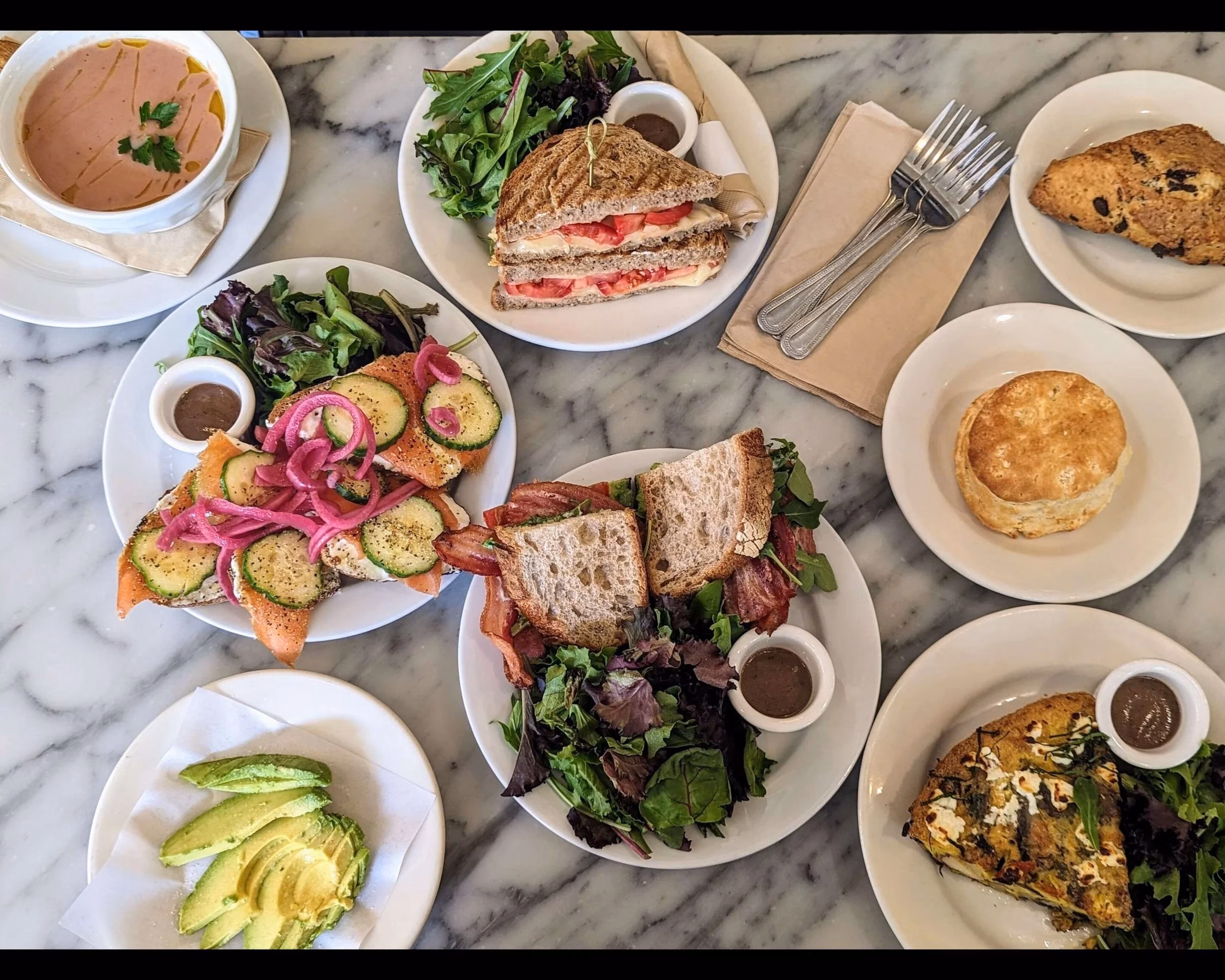 Various brunch items including sandwiches, soup, scone, biscuit, and frittata.