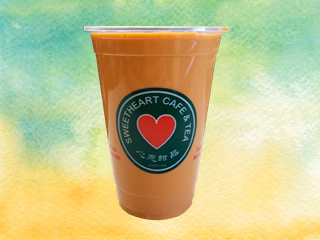 Plastic cup with orange-brown drink and Sweetheart Cafe & Tea logo.