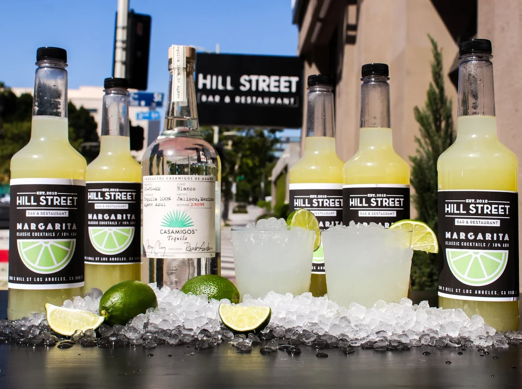 Hill Street Bar margarita bottles, tequila, and prepared cocktails on ice.