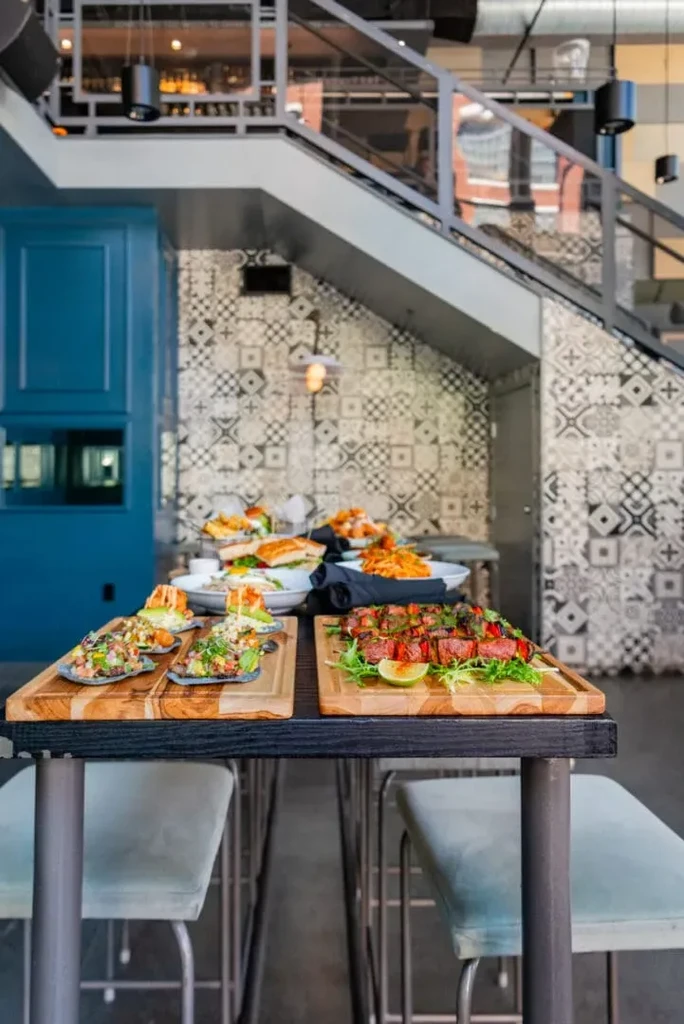 Restaurant interior featuring ceviche tostadas, steak skewers, and elegant architecture.