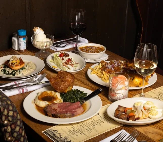 An artfully arranged feast of various dishes on a cozy restaurant table.