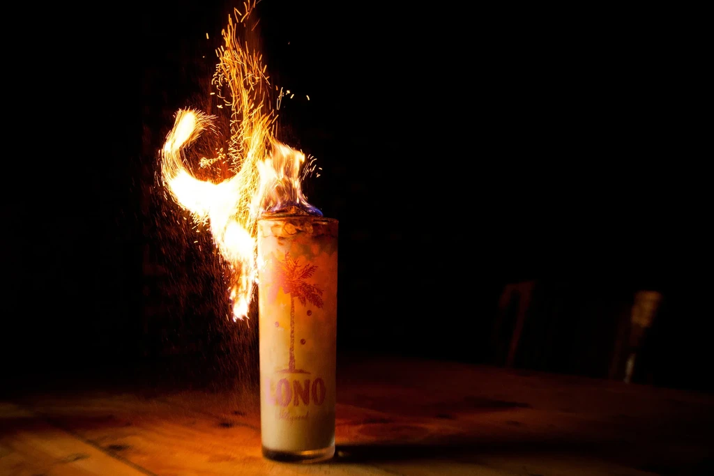 Intensely flaming "LONO" cocktail glass with palm tree design.