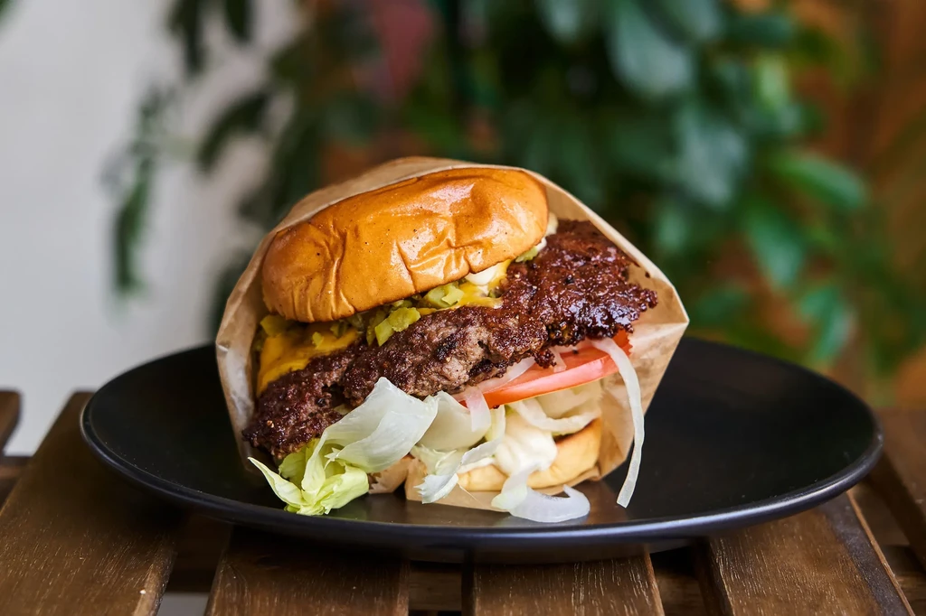 Smash burger with two beef patties, melted cheese, and fresh toppings.