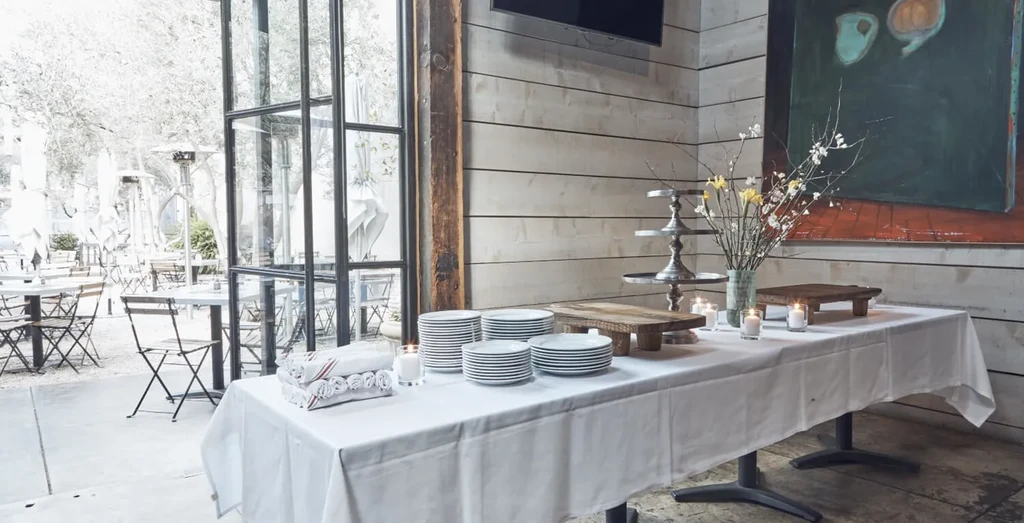 Empty restaurant dining room with buffet table connected to outdoor patio.