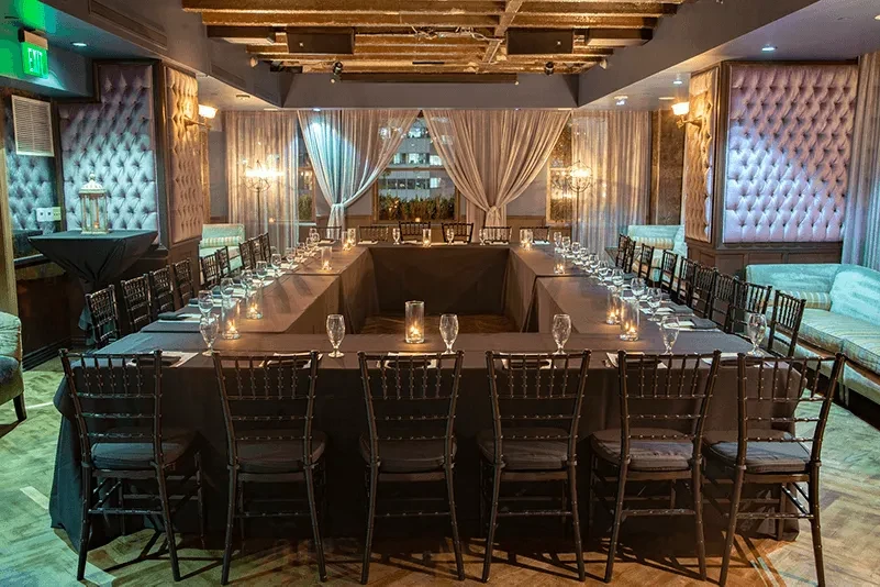 U-shaped dining table in an upscale private room with candles.