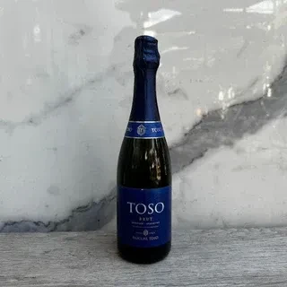 Dark blue-green TOSO BRUT sparkling wine bottle with blue foil.