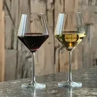 Two modern geometric wine glasses with red and white wine.