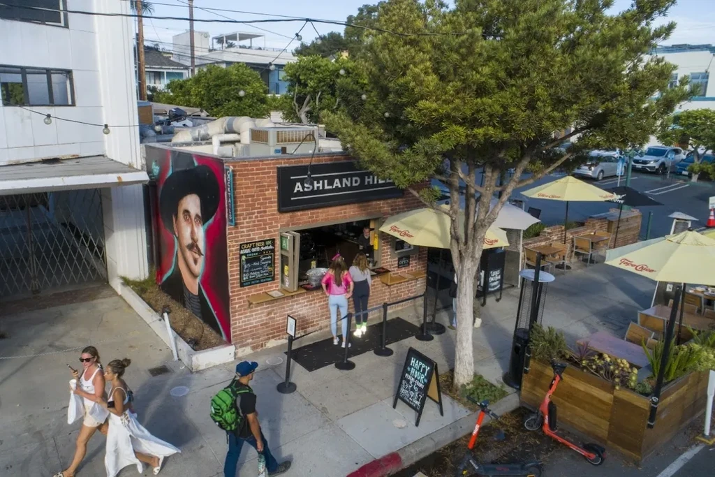 Ashland Hills urban restaurant with walk-up window, mural, and outdoor dining.