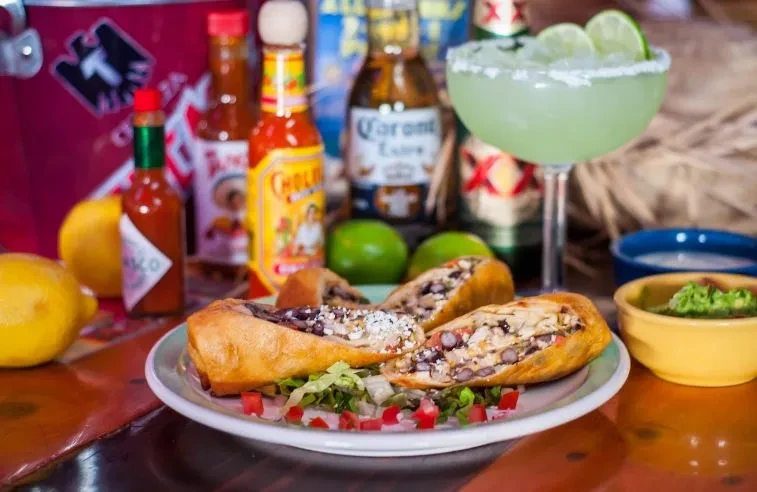 Tex-Mex chimichangas, hot sauces, margarita, beer, and guacamole.