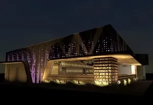 Modern geometric building at night with purple and white uplighting.