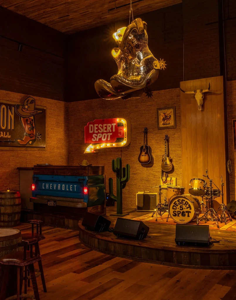 Desert 5 Spot Western bar interior, stage, truck counter, and themed decor.