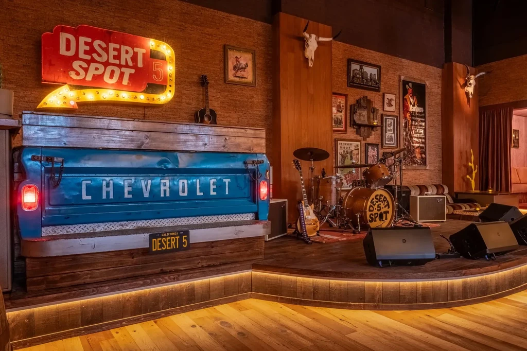 Rustic bar interior of Desert Spot 5 with stage and vintage decor.