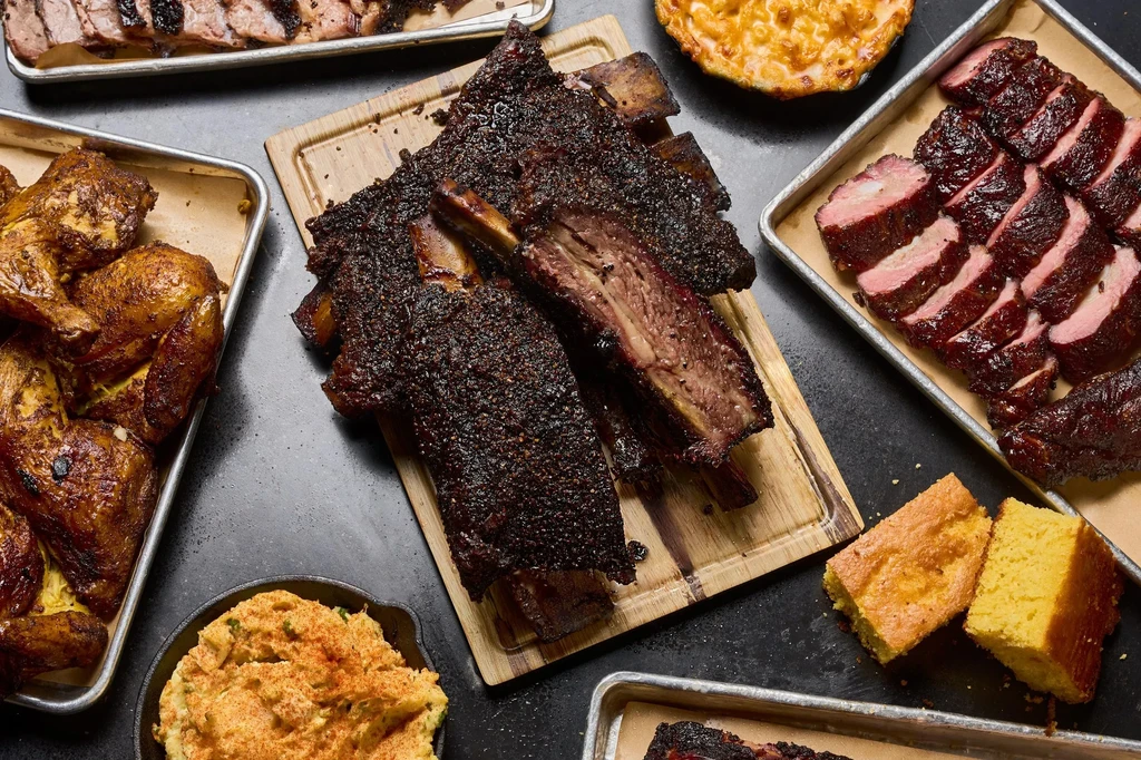 Generous spread of smoked beef ribs, chicken, brisket, mac and cheese, cornbread.