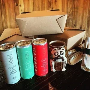 HAMAKA cold brew coffee, matcha, hibiscus cans with mug and takeout boxes.