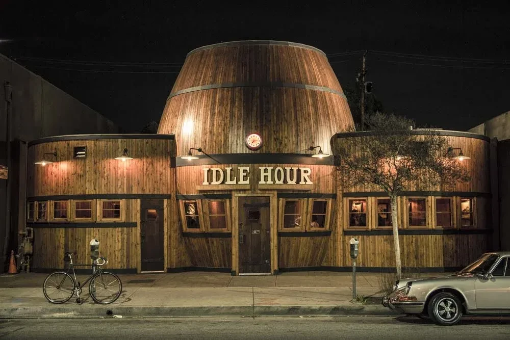 IDLE HOUR building at night, shaped like a giant wooden barrel.