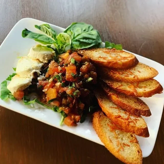 Soft cheese, tomato, and basil bruschetta with toasted baguette.