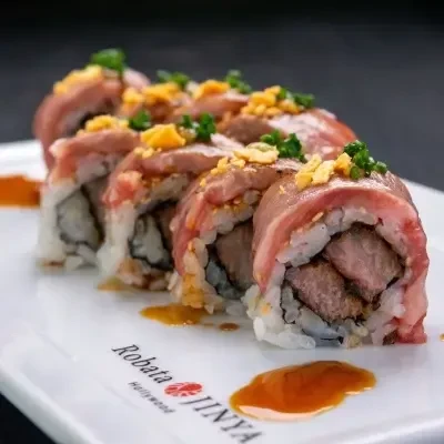 Robata Jinya's surf and turf sushi with chives and sauce.