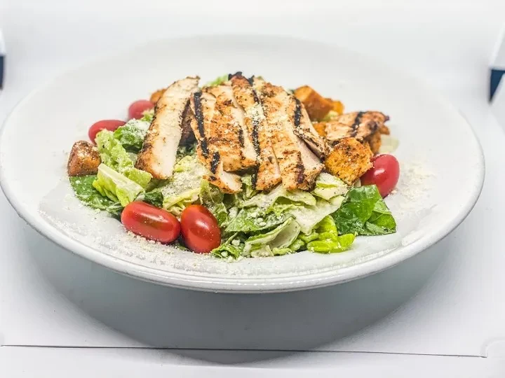 Caesar salad with grilled chicken, tomatoes, croutons, and Parmesan.