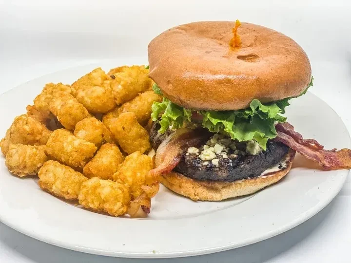 A blue cheese bacon burger with lettuce and crispy tater tots.