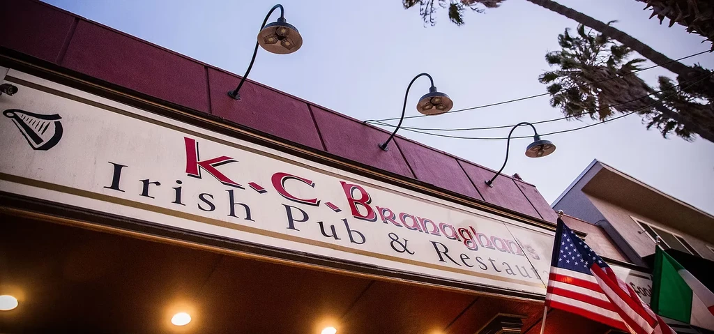 K.C. Branaghan's Irish Pub sign, well-lit beneath a red awning.
