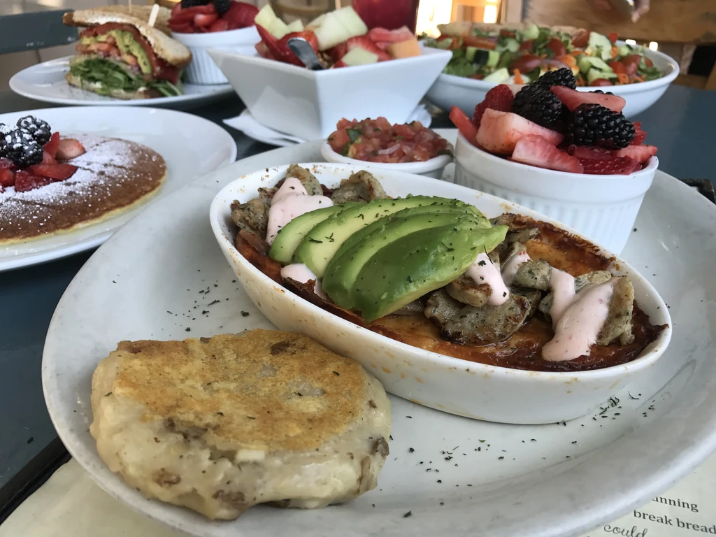 A vibrant table spread of breakfast and brunch dishes.