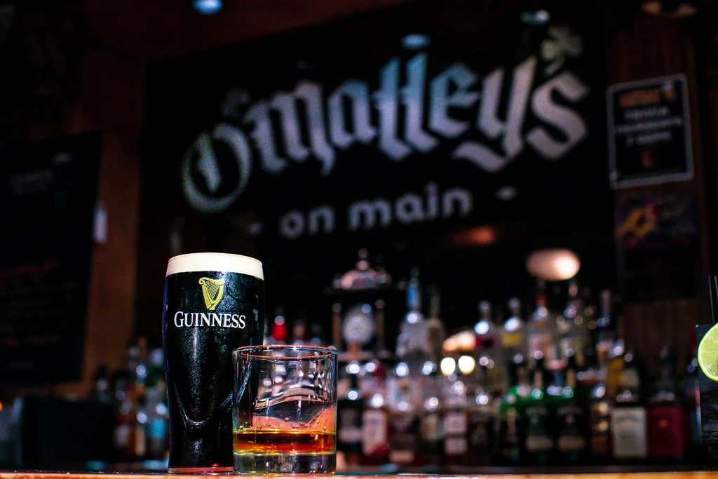 Guinness pint and whiskey glass on a bar counter at O'Malley's.