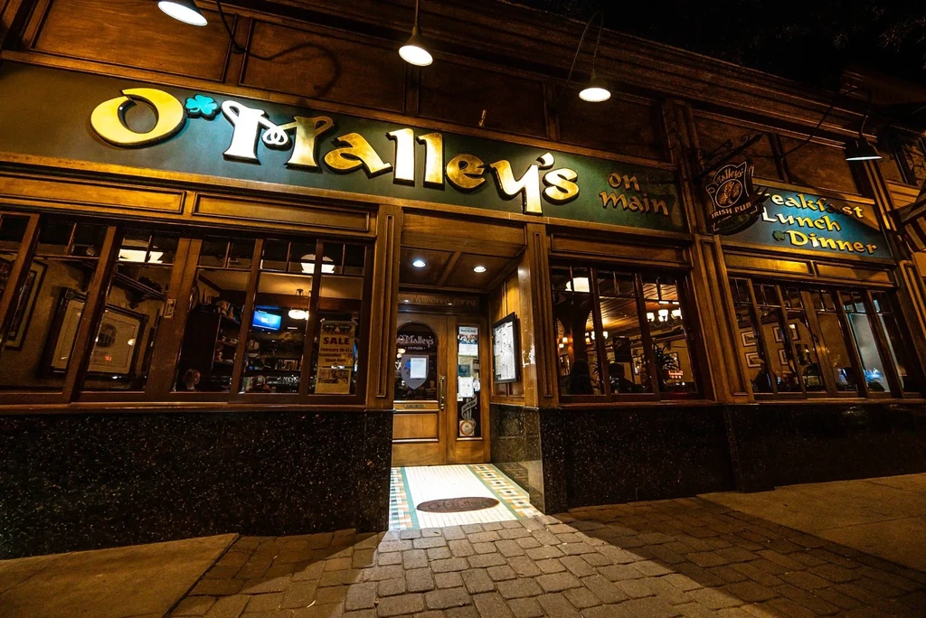 O'Malley's on Main Irish pub exterior, warmly lit at night.
