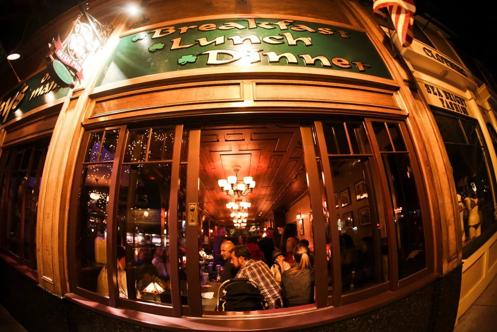 Fisheye view of a warmly lit Irish pub at night.