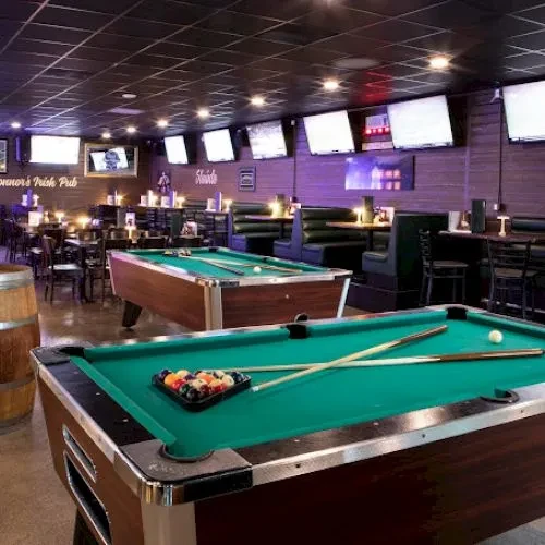 Two green-felt pool tables in Connor's Irish Pub.