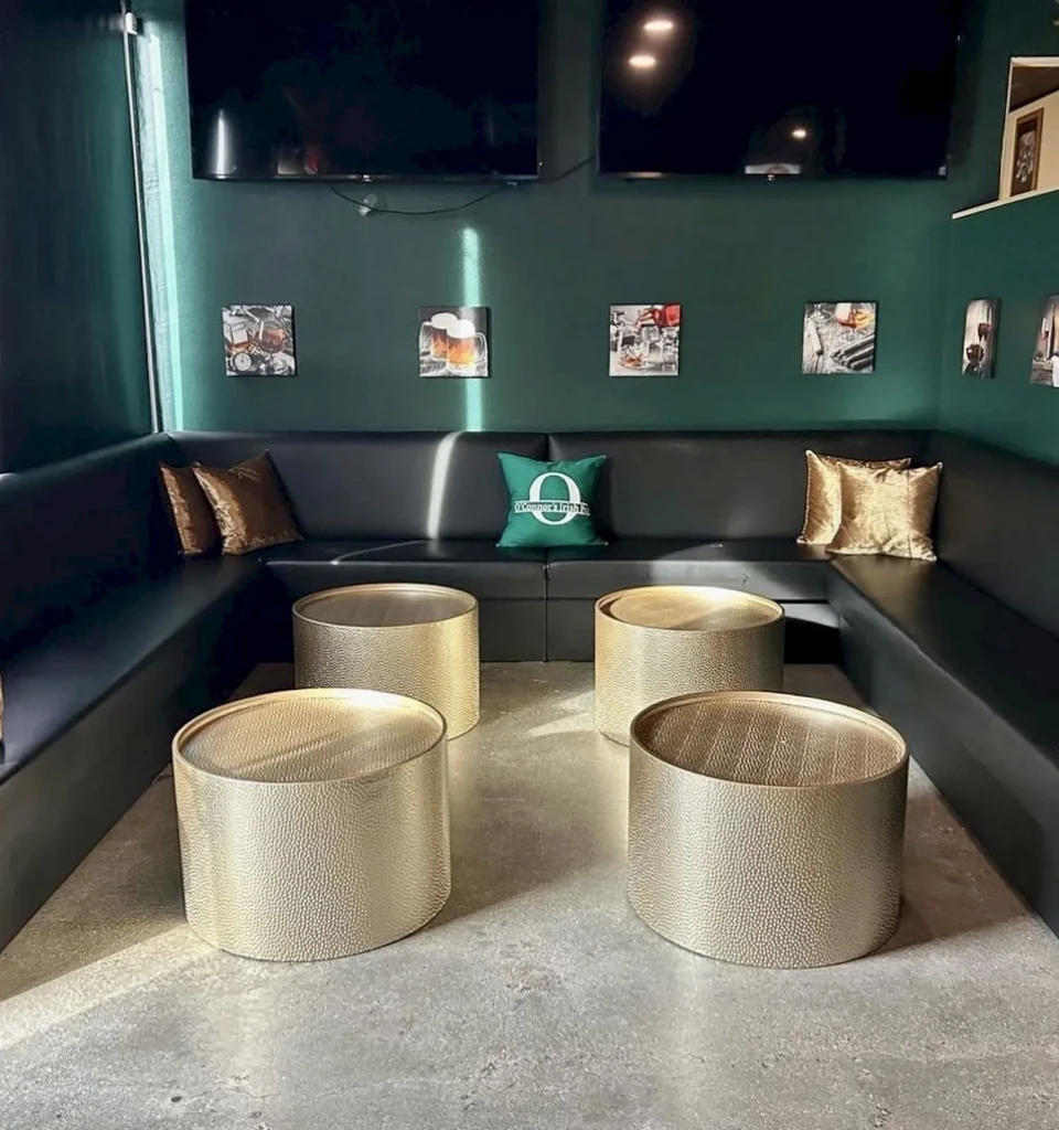 O'Connor's Irish Pub interior: black booths, gold tables, wall TVs.