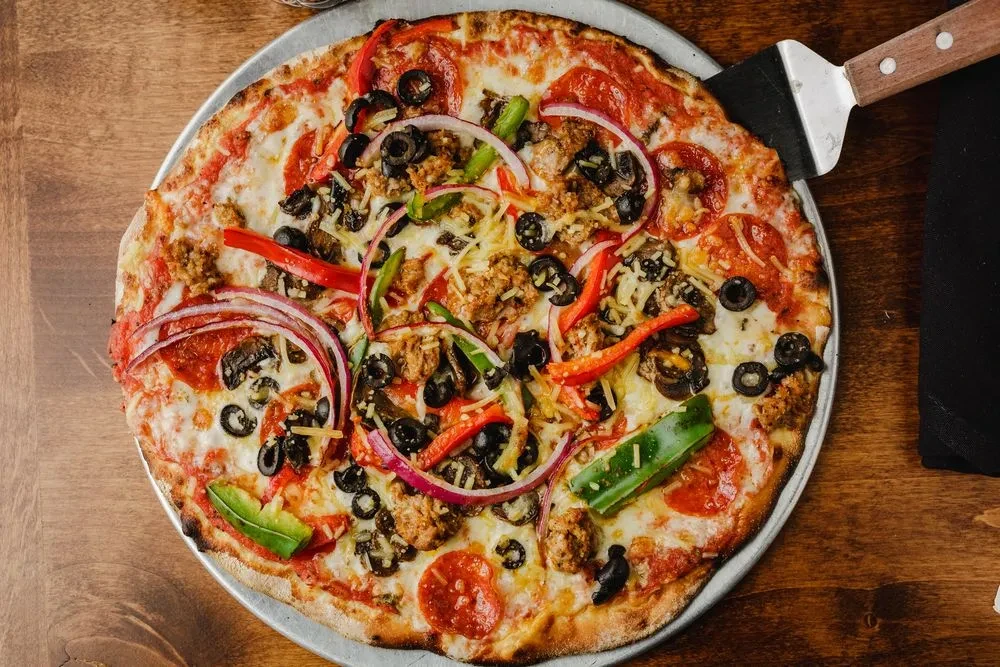 Vibrant, fully loaded pizza with pepperoni, sausage, and vegetables.