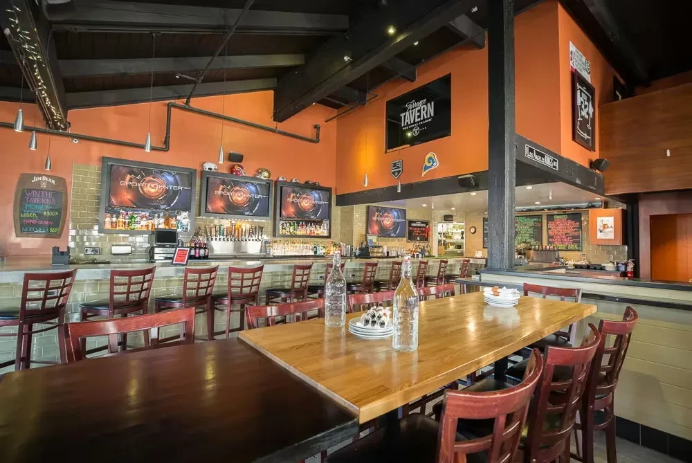 Empty modern sports bar interior with Terrace Tavern signage and TVs.
